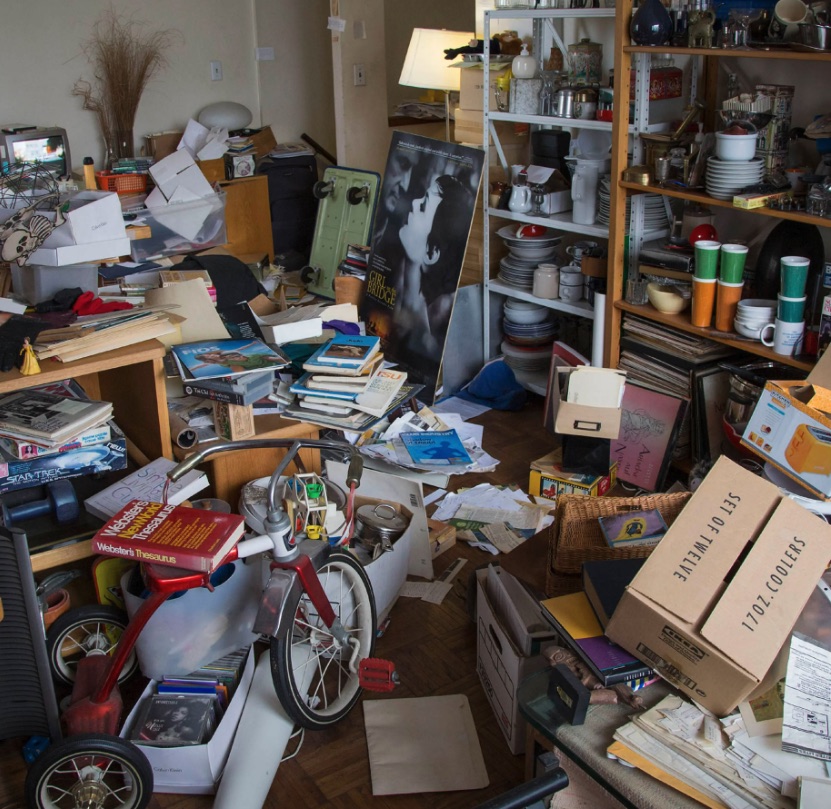 Cluttered room with household collections before Clawson sorting help